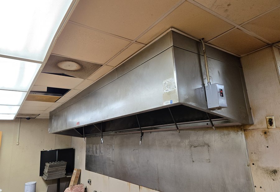 Close before photo of stained ceiling tiles and existing mechanical conflicts